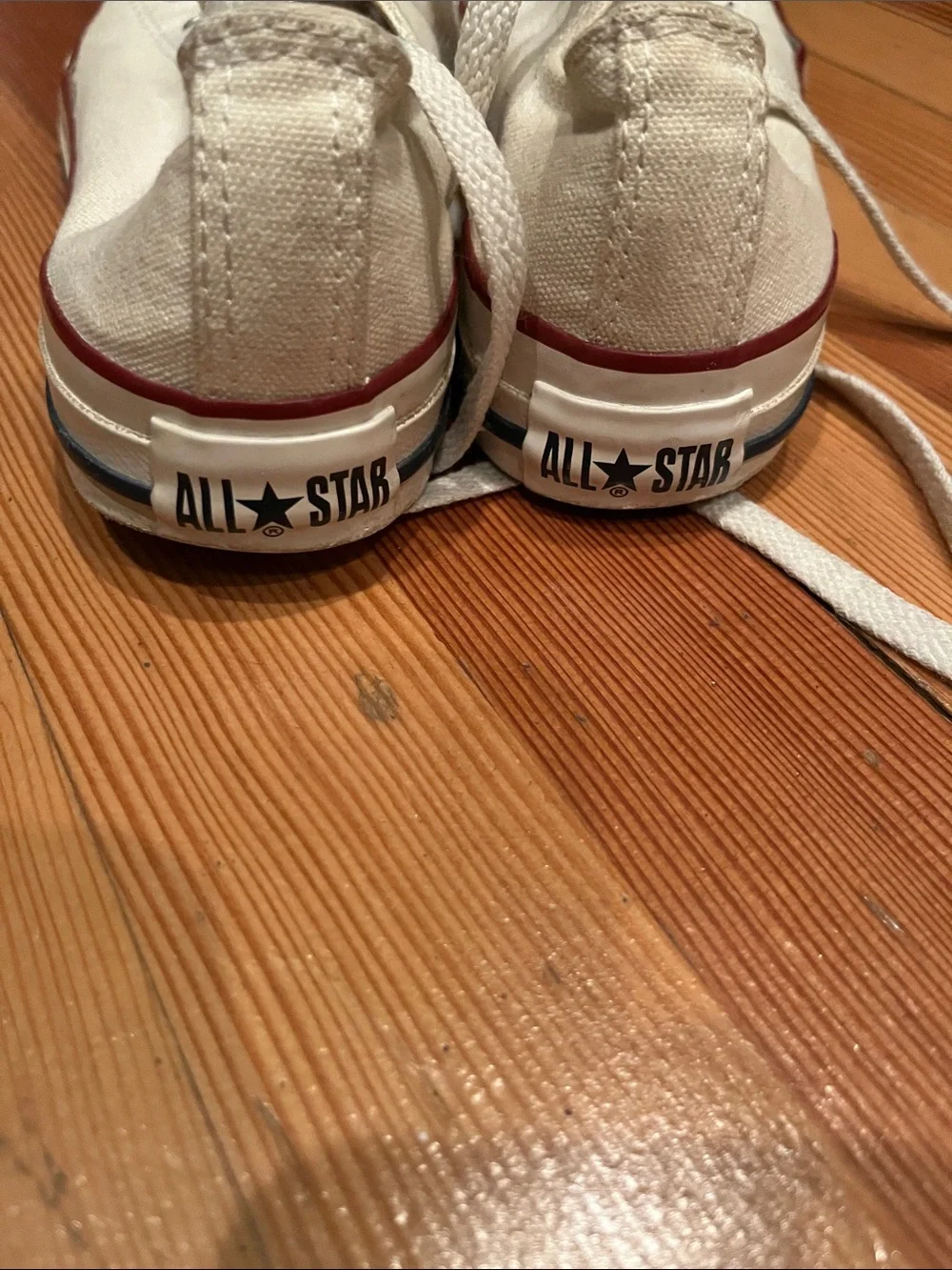 Converse low-top canvas sneakers in white with red trim